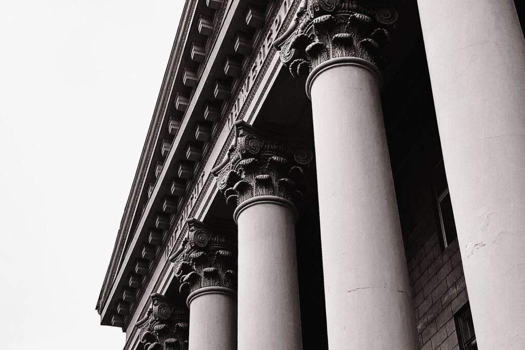 Black and white image highlighting the grandeur of classical columns in Dnipro, Ukraine.